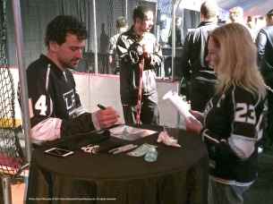 Right wing Justin Williams signs an autograph for a fan