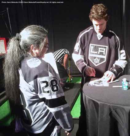 Center Colin Fraser signs an autograph for a fan