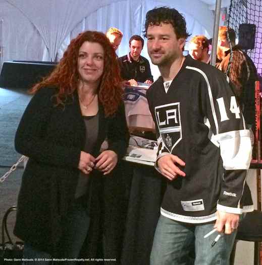Right wing Justin Williams poses for a photograph with a fan